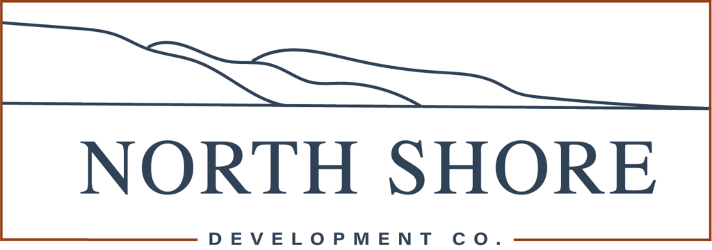 logo for north shore development co. with an illustration of hills coming down to a shoreline